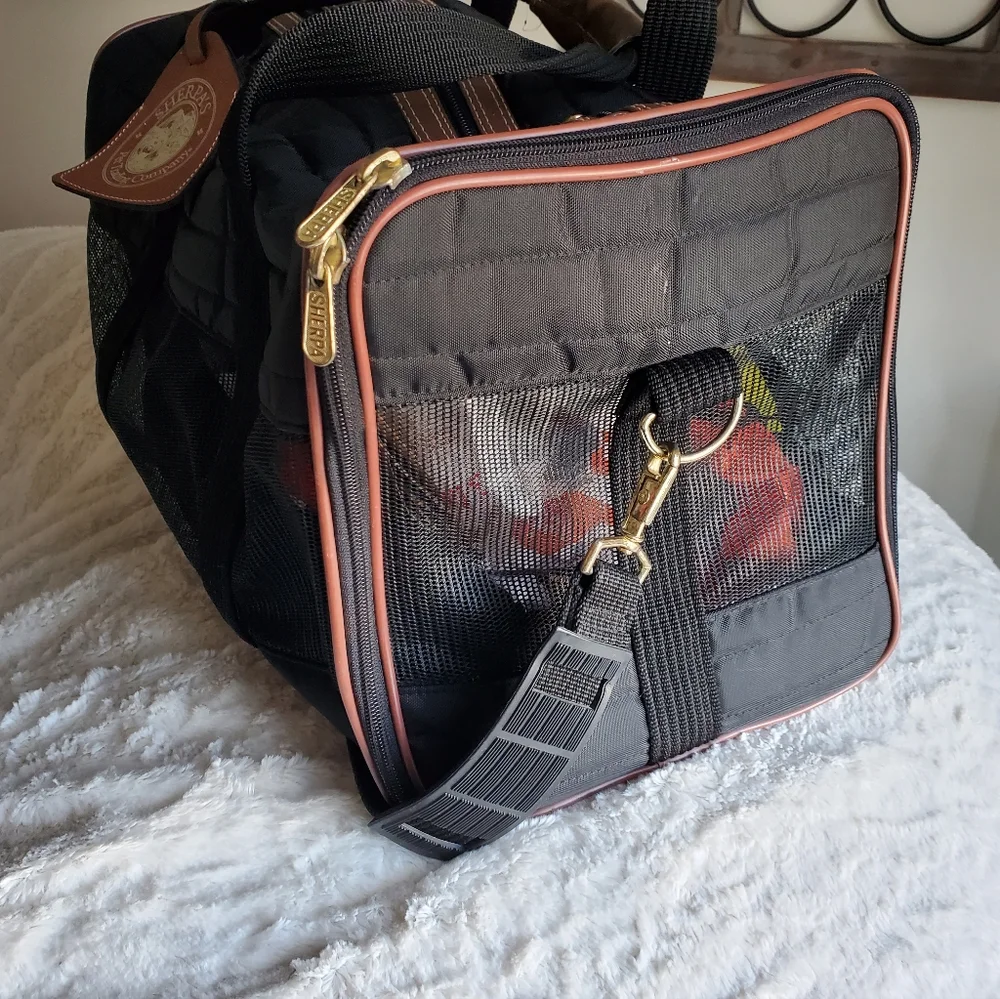 SHERPA'S mid size pet carrier with handles and shoulder strap.